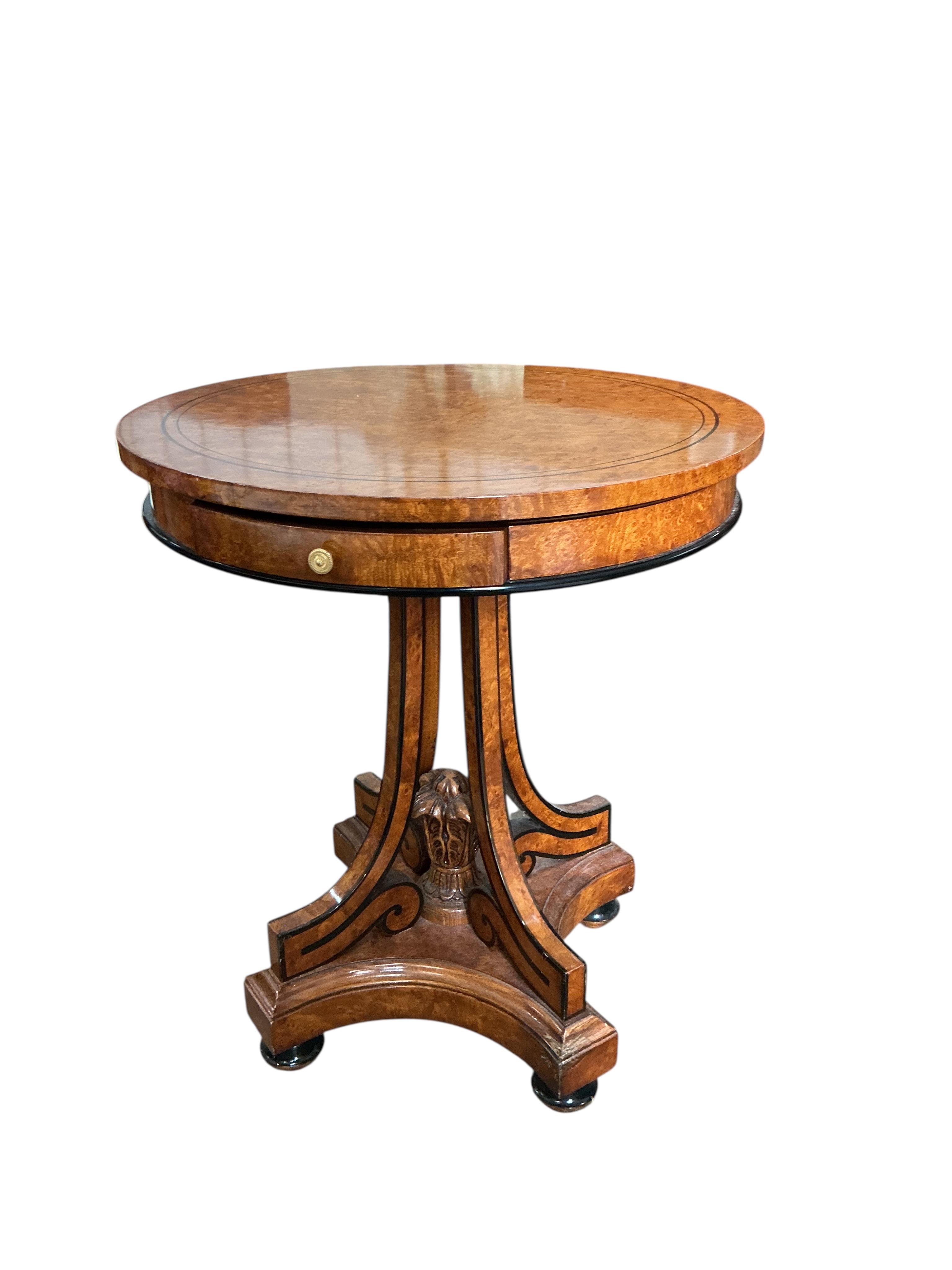 A Regency style part ebonised bird's eye maple circular centre table, diameter 64cm, height 74cm
